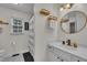 Bathroom featuring a modern sink and faucet with a window view and round mirror at 2003 Zbonack Ct, Creedmoor, NC 27522