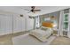 Bedroom featuring a ceiling fan, two windows, and a headboard with matching nightstands at 2003 Zbonack Ct, Creedmoor, NC 27522
