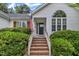 Welcoming entryway with brick steps, decorative plants, and a charming arched window above the front door at 2003 Zbonack Ct, Creedmoor, NC 27522