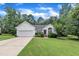 Charming home featuring a manicured lawn, attached garage, and well-maintained landscaping at 2003 Zbonack Ct, Creedmoor, NC 27522
