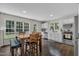 Charming kitchen with white cabinets, stainless steel appliances, and adjacent dining area with bench seating at 2003 Zbonack Ct, Creedmoor, NC 27522