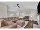 Large living room featuring a corner sofa, ceiling fan, and a fireplace with a large TV at 2003 Zbonack Ct, Creedmoor, NC 27522