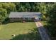 Aerial shot of charming brick house with a long driveway and well-manicured lawn at 3603 Grimes Ave, Durham, NC 27703