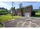 View of the home's backyard featuring a brick exterior, patio, and basketball area at 3603 Grimes Ave, Durham, NC 27703