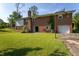 Brick home with a spacious backyard, patio, attached garage, and basketball hoop at 3603 Grimes Ave, Durham, NC 27703