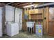 Basement laundry area with washer, utility sink, and open shelving at 3603 Grimes Ave, Durham, NC 27703