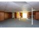 Finished basement featuring wood paneling, a brick fireplace, and carpeted flooring at 3603 Grimes Ave, Durham, NC 27703