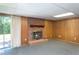 Cozy basement area featuring a brick fireplace and sliding glass doors to the outside at 3603 Grimes Ave, Durham, NC 27703
