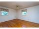 Well-lit bedroom with gleaming hardwood floors and two large windows offering plenty of natural light at 3603 Grimes Ave, Durham, NC 27703
