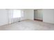 Bright, empty bedroom featuring neutral carpet and large windows at 3603 Grimes Ave, Durham, NC 27703