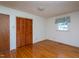 Bedroom featuring lustrous hardwood floors, louvred closet doors, and a ceiling light fixture at 3603 Grimes Ave, Durham, NC 27703