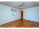 Bedroom with hardwood floors, ceiling fan, and a louvred closet door at 3603 Grimes Ave, Durham, NC 27703