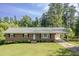 Well-maintained brick home with a covered parking area and a neatly kept lawn at 3603 Grimes Ave, Durham, NC 27703