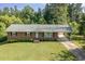 Well-maintained brick home with a covered parking area and a neatly kept lawn at 3603 Grimes Ave, Durham, NC 27703