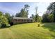 Charming brick home with a lush, green front yard and mature trees at 3603 Grimes Ave, Durham, NC 27703