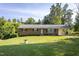 Charming brick home with a lush, green front yard and mature trees at 3603 Grimes Ave, Durham, NC 27703
