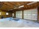 Garage interior showing unfinished walls, storage, and two white garage doors at 3603 Grimes Ave, Durham, NC 27703