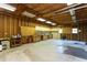 The garage interior features exposed studs, work bench, storage, and concrete floors at 3603 Grimes Ave, Durham, NC 27703