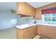 Functional kitchen with wooden cabinets and white appliances at 3603 Grimes Ave, Durham, NC 27703