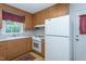 Functional kitchen with wooden cabinets and white appliances at 3603 Grimes Ave, Durham, NC 27703