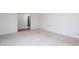 Spacious living room with carpet flooring and an open doorway to a wallpapered area at 3603 Grimes Ave, Durham, NC 27703