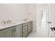 Bathroom with double vanity, light green cabinets, and tiled floors at 104 Birdie Court, Pittsboro, NC 27312