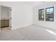 Bright carpeted bedroom with two windows and access to an ensuite bathroom and closet at 104 Birdie Court, Pittsboro, NC 27312