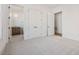 Carpeted bedroom with doorways that lead to the bathroom and closet at 104 Birdie Court, Pittsboro, NC 27312