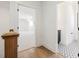 Bright hallway leads to a carpeted room and bathroom with geometric tiled floors at 104 Birdie Court, Pittsboro, NC 27312