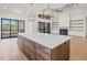 Kitchen features an island with marble countertops and modern lighting at 104 Birdie Court, Pittsboro, NC 27312