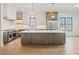 Spacious kitchen island with white countertop and modern appliances plus hardwood flooring at 104 Birdie Court, Pittsboro, NC 27312