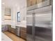 Modern kitchen features stainless steel Sub-Zero refrigerator and white subway tile backsplash at 104 Birdie Court, Pittsboro, NC 27312