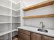 Pantry featuring white shelving, a sink and a wooden countertop at 104 Birdie Court, Pittsboro, NC 27312