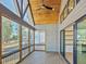 View of screened-in porch with wood ceiling, ceiling fan and view of the backyard at 104 Birdie Court, Pittsboro, NC 27312