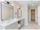 Dual vanity sinks and an open view of a glass enclosed shower are features of this bathroom at 600 N Roxboro St # 41, Durham, NC 27701