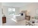 Bright bedroom featuring neutral walls, a queen bed, and a cozy seating area to relax at 600 N Roxboro St # 41, Durham, NC 27701