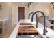 A modern kitchen island with dual faucets and sleek appliances, with wood accents at 600 N Roxboro St # 41, Durham, NC 27701