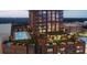 Luxury rooftop pool with lounging areas and city views at twilight at 400 W Main St # 2010, Durham, NC 27701