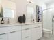 Modern bathroom with double vanity, sleek mirrors, and glass-enclosed shower at 610 Walnut Hts Dr # 102, Raleigh, NC 27610