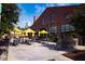 Inviting outdoor dining area with tables, umbrellas, and brick building backdrop at 610 Walnut Hts Dr # 102, Raleigh, NC 27610