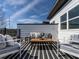 Cozy rooftop deck offering relaxing outdoor seating space with a stylish black and white rug at 610 Walnut Hts Dr # 102, Raleigh, NC 27610