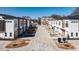 Street view featuring townhomes with modern architecture and a brick-paved road at 610 Walnut Hts Dr # 102, Raleigh, NC 27610