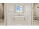 Luxurious bathroom with soaking tub and marble floors at 291 Riverstone Dr, Pittsboro, NC 27312