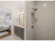 Modern bathroom with gray vanity, patterned floor, and a shower stall at 291 Riverstone Dr, Pittsboro, NC 27312
