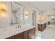 Bathroom boasts double vanity and large mirror at 291 Riverstone Dr, Pittsboro, NC 27312