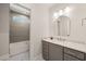 Modern bathroom with gray vanity and subway tile shower at 291 Riverstone Dr, Pittsboro, NC 27312