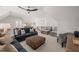 Bright bonus room with sectional sofa, ottoman, and wet bar at 291 Riverstone Dr, Pittsboro, NC 27312
