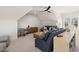 Spacious bonus room with comfy seating and a ceiling fan at 291 Riverstone Dr, Pittsboro, NC 27312