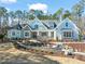 Two-story house with stone and siding, landscaped yard, and a walkway at 291 Riverstone Dr, Pittsboro, NC 27312