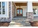 Elegant front entrance with stone accents and double doors at 291 Riverstone Dr, Pittsboro, NC 27312